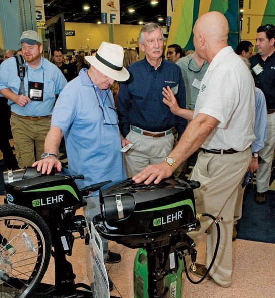 Captain Bernardo Herzer talks about his propane outboard motor at the Miami Boat Show. Photo by Glenn Hayes