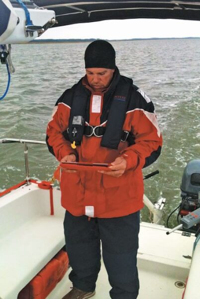 Clint checks in with his tablet. Photo by Terry Boram