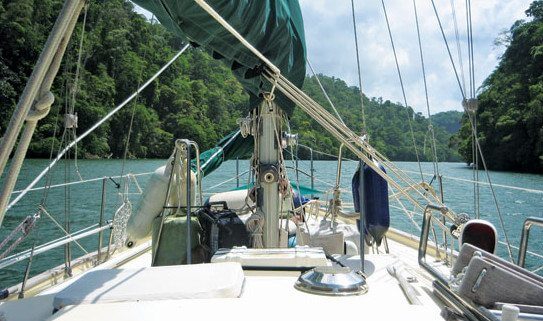 Traveling along the calm waters of Rio Dulce through deep gorges fringed with jungle