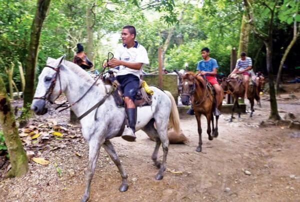 Guides on horseback in Tayrona National Park. Photo: Axel Busch