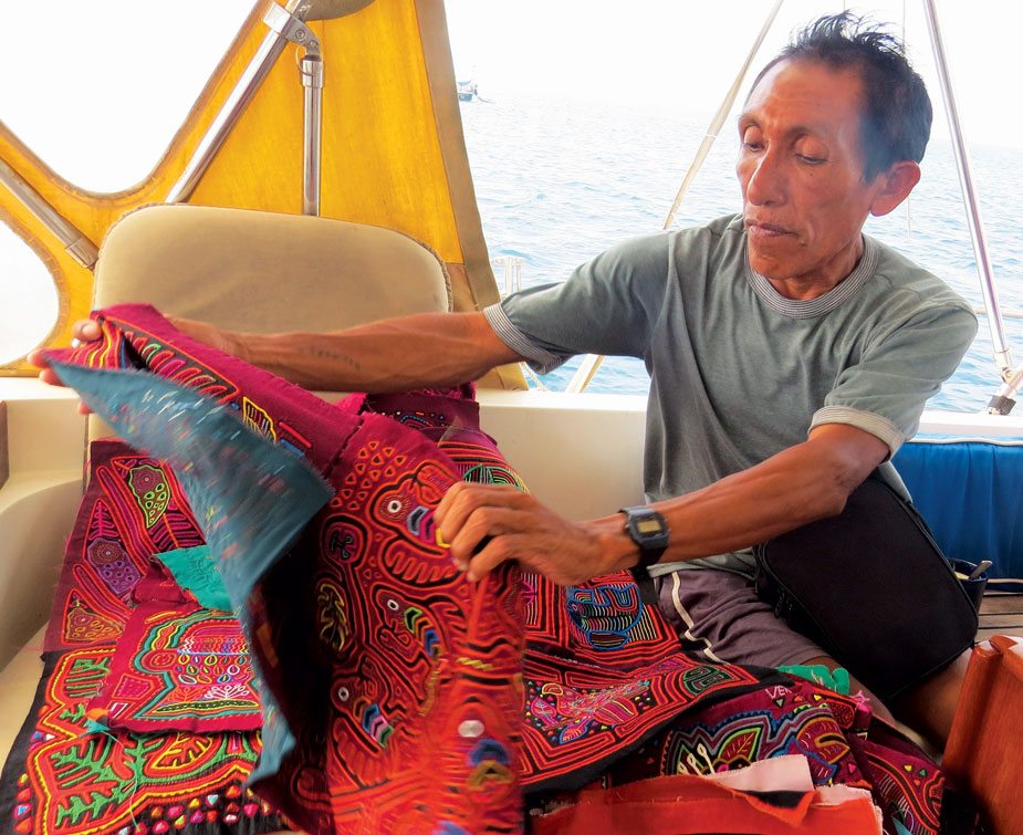 Master mola maker, Venancio, and his molas. Photo by Barbara Hart