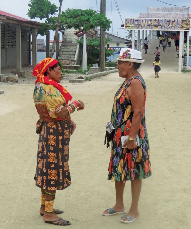 Two Guna ladies in Nargana, both colorfully dressed; one traditionally and one for the city. Photo by Barbara Hart