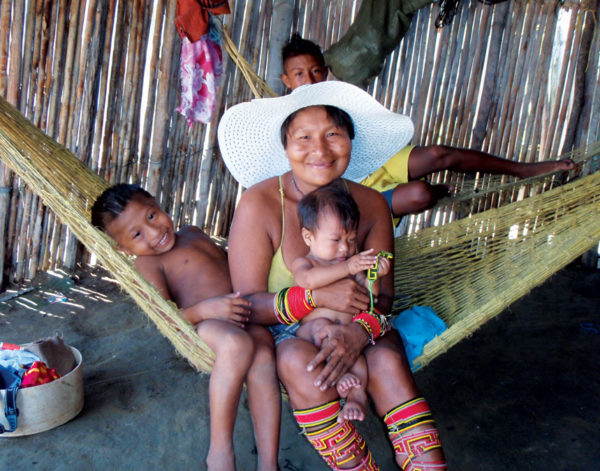 This happy Kuna family had several more kids in their basic hut, most of them with snotty noses and eye infections