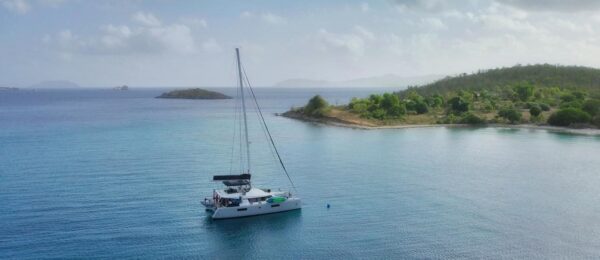 A catamaran moored to a new Helix-type mooring ball in a picturesque harbor off of St. Thomas.