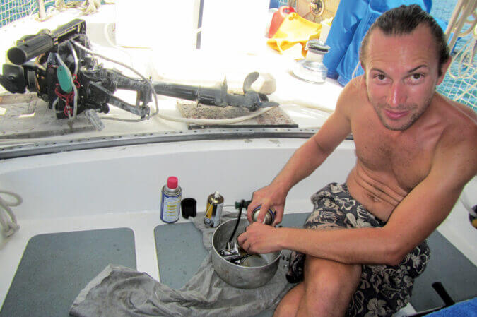Rinsing the outboard innards with diesel. Photo by Birgit Hackl and Christian