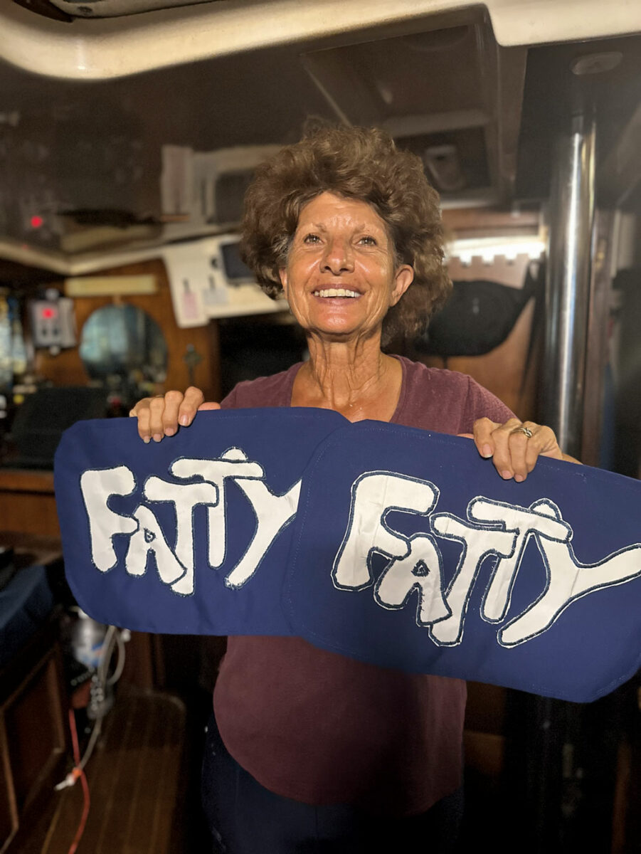 Carolyn does all our sewing—seen here with our dinghy cover labels.