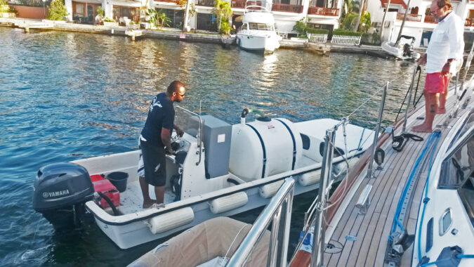 Slurpy, EPIC sewage pumpout boat, alongside a yacht in Simpson Bay Lagoon, Sint Maarten